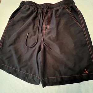 CALVIN KLEIN MENS SWIM TRUNKS. SIZE MEDIUM. BLACK WITH ORANGE STITCHING
